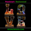 Decorative letters spelling 'LOVE' with floral designs on a black background, featuring the brand 'Passionart - Resinzwood'.