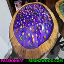 Round table with wooden edge and purple resin embedded with colorful stones, brand 'PassionArt' visible.