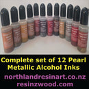 Row of small cosmetic bottles with black caps on a white background