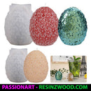 Collection of decorative candles with textured surfaces, including a glass with a drink and Eiffel Tower model in the background.