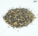 Mixture of black and yellow granules on a white background