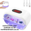 Nail polish dryer with digital display and USB cable on a white background