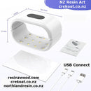 White LED lamp with USB connection, dimensions, and packaging on a white background.