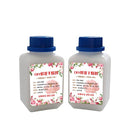 Two white plastic bottles of DIY floral drying agent with blue caps and pink floral labels, shown on a plain white background.