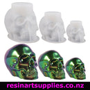 Set of skull-shaped silicone molds with a colorful resin skull on a white background, featuring the brand 'resinartsupplies.co.