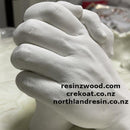 White hand sculpture with multiple website URLs overlaid