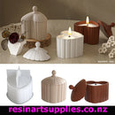 Decorative candles and containers on a table with 'resinartsupplies.co.nz' branding.