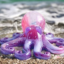 Colorful octopus-shaped object on a beach