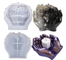 Set of four hand-shaped silicone molds on a white background