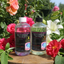 Two bottles of PassionArt Craft Resin on a wooden surface with flowers in the background