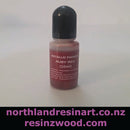 Bottle of metallic pigment labeled 'Ruby Red' on a white background with branding text at the bottom.